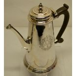 An early George II coffee pot, the tapering body engraved a coat of arms within a baroque cartouche,