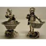 A cast pair of late Victorian figural salts of a gardener and his companion, in eighteenth century