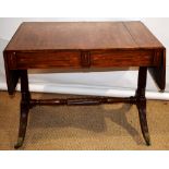 A George IV mahogany veneered sofa table, the rectangular top with end flaps, having rounded