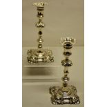 A pair of George II cast silver candlesticks, the spool shape candleholders with square detachable