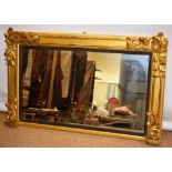 A William IV gilt frame overmantle mirror, the rectangular plate with an ebonised reeded slip,