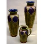 A pair of early twentieth century Royal Doulton stoneware vases, decorated sponge coloured panels,