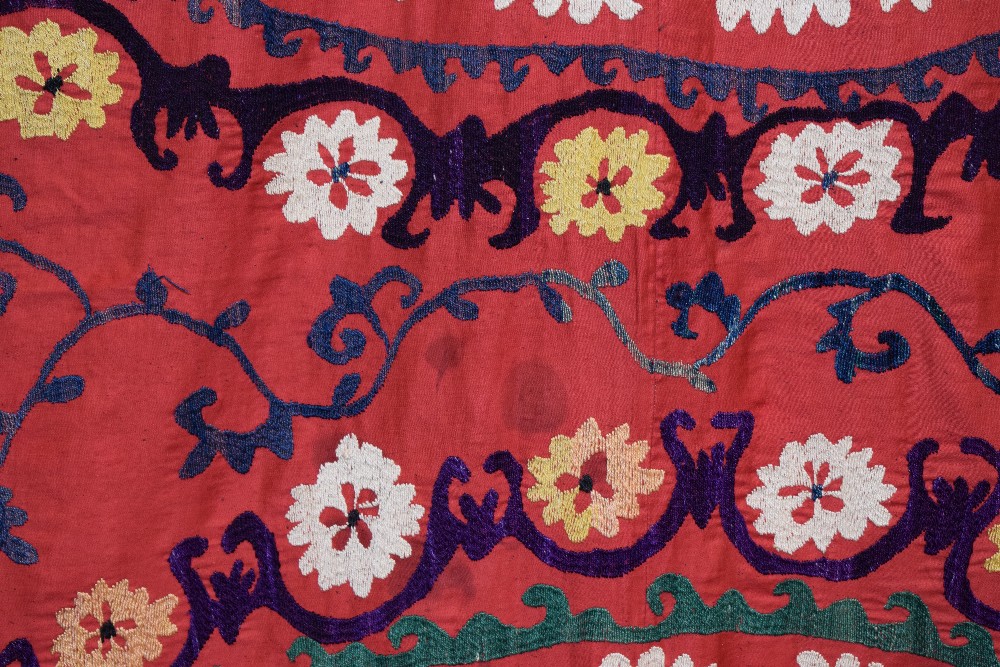 Uzbek red cotton suzani, Uzbekistan, 20th century, embroidered in basma stitch in bright silks, - Image 6 of 8