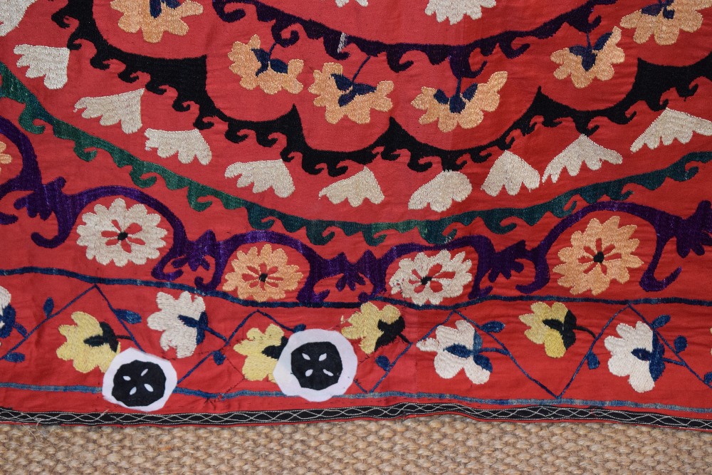 Uzbek red cotton suzani, Uzbekistan, 20th century, embroidered in basma stitch in bright silks, - Image 7 of 8