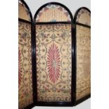 Three Ottoman velvet catma now set into a domed top ebonised three-fold screen, Brusa, south west