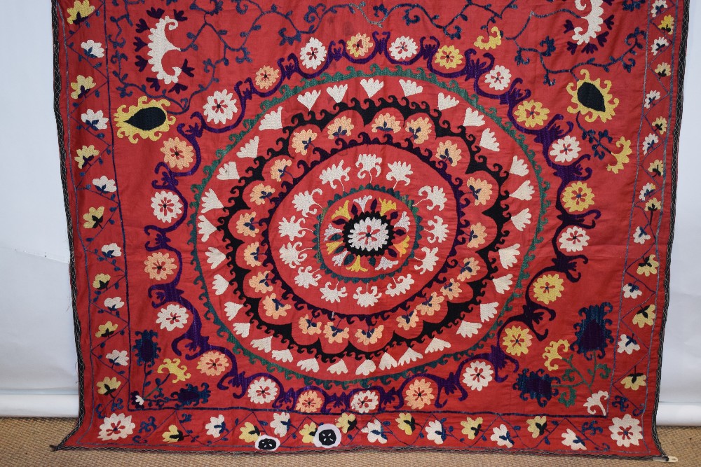 Uzbek red cotton suzani, Uzbekistan, 20th century, embroidered in basma stitch in bright silks, - Image 5 of 8