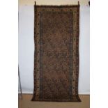 Kurdish long rug, north west Persia, early 20th century, 10ft. 2in. X 4ft. 5in. 3.10m. X 1.35m.