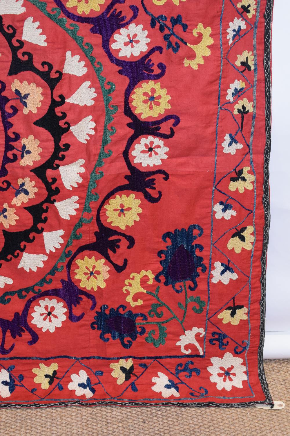 Uzbek red cotton suzani, Uzbekistan, 20th century, embroidered in basma stitch in bright silks, - Image 2 of 8