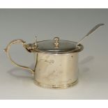 A silver mustard pot with acanthus cast handle, reeded lower rim,