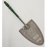 A George III silver plated pierced and engraved cake slice, stained green turned ivory handle,