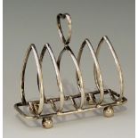 A silver heart shaped toast rack with inverted conforming handle, ball feet, by Elkington & Co Ltd,