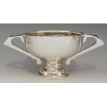 A silver two handled trophy, folded rim, angular handles, circular pedestal foot,