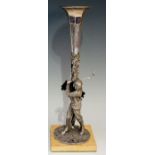 A silver plated spill vase, the base cast as a golfer taking a swing before a trunk,