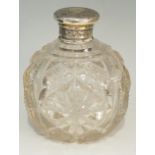 A large globular scent bottle, the glass body heavily cut with diamonds and stars,