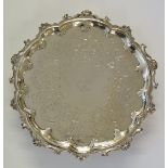 A silver salver with central armorial crest surround by motto 'Magnus hippocrates tu nobis maior',