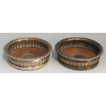 A pair of Sheffield plate wine coasters, half lobed bodies, gadrooned rims,