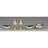 A selection of silver items to include: a pair of pepper pots, half lobed bodies, spire finials,