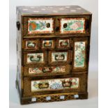 A good Japanese black lacquer cabinet decorated overall with geometric motifs in gilt,