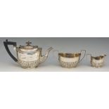 A Victorian three piece silver tea service comprising: teapot, cream jug and sucrier,