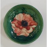 Moorcroft - a circular pedestal dish decorated to the centre with a pink anemone,