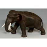 A Japanese bronze model of an elephant with ivory tusks, 18cm wide overall, seal mark,