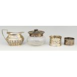 A selection of silver items to include: a cream jug with half gadrooned body and angular handle,