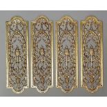 A set of four Edwardian gilt brass door push plates with central torch flanked by ribbon tied