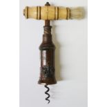 A 19th Century double action bronze corkscrew with applied crown, ivory handle with brush,