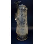 An oversized glass tankard, the body elaborately engraved with stags and woodland, applied handle,