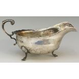 A silver sauce boat of conventional form, flying acanthus cast handle,