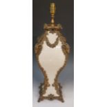 An ornate cream crackle glazed pottery table lamp with ornate brass ram's head floral pendant and