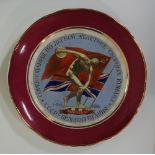 A Russian porcelain shaped circular plate painted to the centre with a discus thrower standing