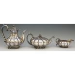 A three piece Sheffield plate tea service comprising: tea pot, coffee pot and milk jug,