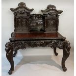 An ornate Japanese stained wooden desk of concave fronted form,