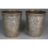 A pair of Iranian silver coloured metal beakers,
