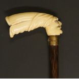 An Edwardian walking stick, the ivory handle carved with head of an Arab,