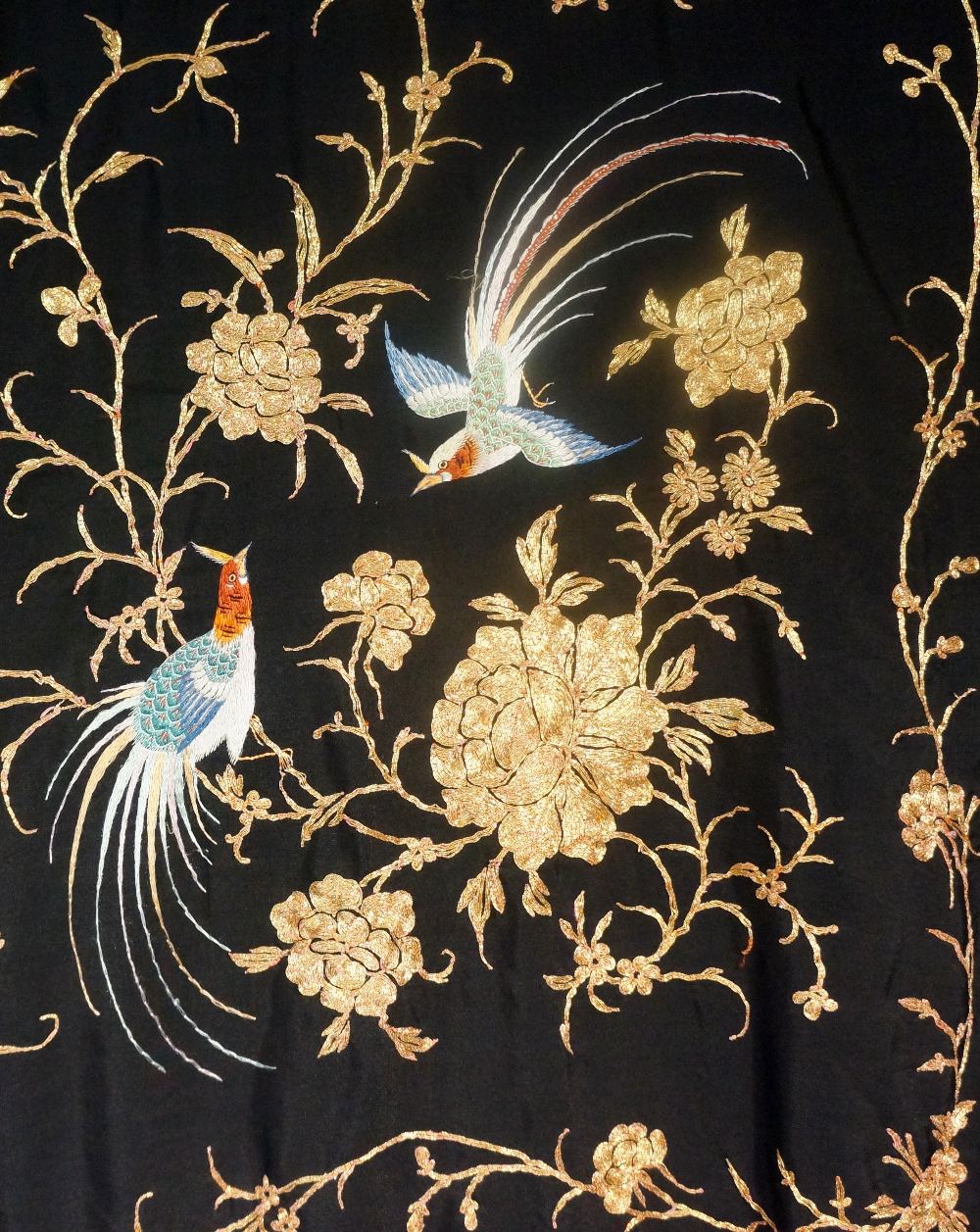 A fine quality black silk shawl finely worked in coloured silks and gold thread with birds,