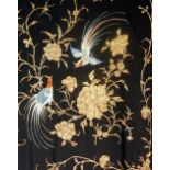 A fine quality black silk shawl finely worked in coloured silks and gold thread with birds,