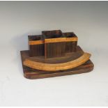 A Macassar ebony and burr amboyna veneered desk tidy of Art Deco design with one large and two