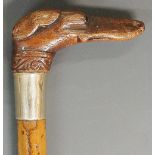 A 19th Century ladies walking stick, the wooden handle carved as a greyhound's head,