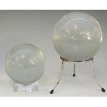 A 10cm diameter crystal ball on a modern stand;