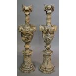 A pair of veined alabaster urns with leafy bird spouts,