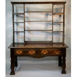 An early George III style oak dresser with rack, the shelved back with flared cornice above a base,