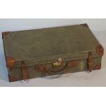 An olive green canvas case with leather mounted corners and straps, red cotton interior,