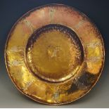 Golfing - a circular copper lacquered brass dish detailed with golfing scenes to the broad border