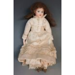 An Armand Marseilles porcelain headed doll with fixed blue eyes,