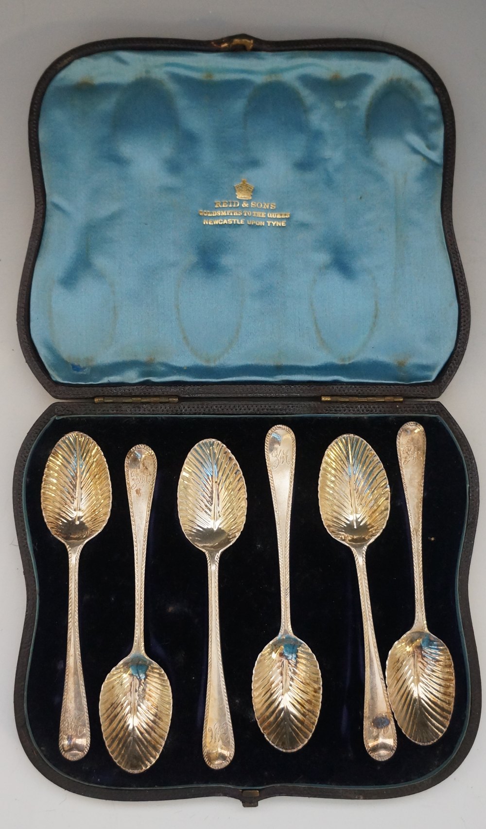 A Victorian cased set of six teaspoons with stylised leaf bowls, each engraved with the initials YM,