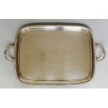 A large silver plated two handled tray with gadrooned rim, plain body,