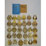 A quantity of horse brasses together with two books,