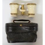 A pair of French ivory cased gilt metal opera glasses,